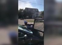 Woman clings onto car in bizarre traffic incident