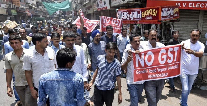 Members of Electrical Merchants' Association stage a demonstration against GST in Ahmedabad, on June 15, 2017. gst, gst strike, gst council, gst rates, arun jaitley, july 1, modi govt, protests against gst, no gst, gst strike