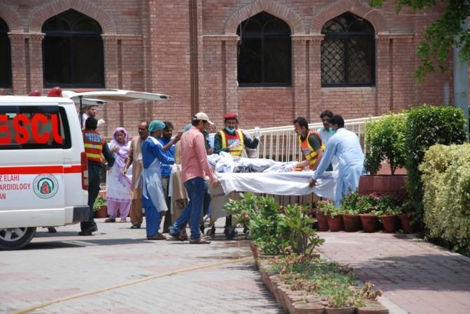 Hospital workers carry in the first victims of a fuel tanker explosion in Bahawalpur at Nishtar hospital in Multan, Pakistan, on June 25, 2017. Pakistan