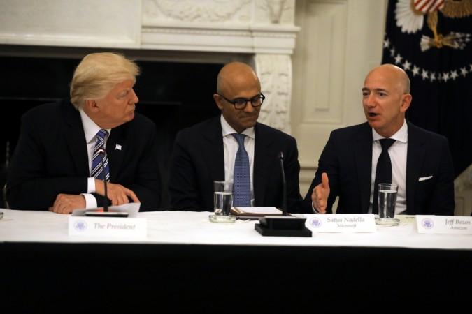 US President Donald Trump and Satya Nadella, CEO of Microsoft Corporation, listen as Amazon CEO Jeff Bezos speaks during an American Technology Council roundtable at the White House in Washington on June 19. REUTERS/Carlos Barria Donald Trump meets corporate heads