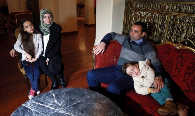 Syrian girl Bana al-Abed (L), known as Aleppo's tweeting girl, poses with her mother Fatemah, her father Ghassan and one of his brothers Laith, during an interview in Ankara, Turkey, on December 22, 2016. Bana Alabed