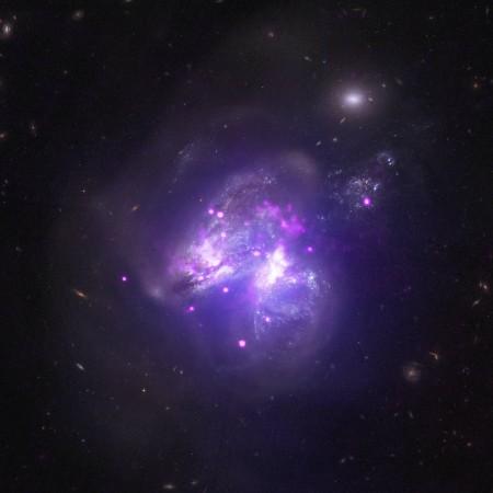 Arp 299 -- a system captured by NASA's Chandra X-ray Observatory located about 140 million light years from Earth-- contains two merging galaxies. nasa, Chandra X-ray observatory, Galactic Goulash, galaxy, space,