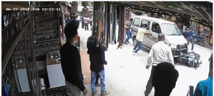 Pedestrians try and stop car which dragged the woman in Rajasthan along with her two-wheeler Woman dragged in Rajasthan