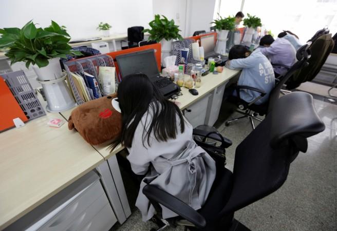 Employees at Goopal Group take a nap in their seats after lunch, in Beijing, China Napping at work