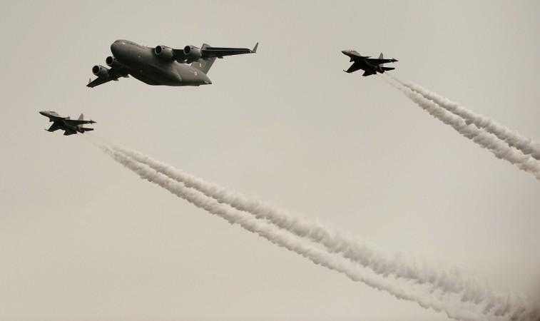 An Indian Air Force C-17 (C) aircraft and two fighter jets perform a fly over during a parade at the Hindon Air Force station on the outskirts of New Delhi on October 8, 2013. Indian fighter aircraft