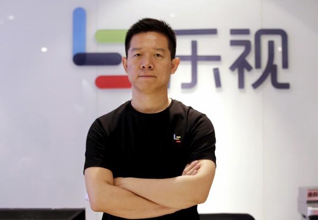 Jia Yueting, co-founder and head of Le Holdings Co Ltd, also known as LeEco and formerly as LeTV, poses for a photo in front of a logo of his company after a Reuters interview at LeEco headquarters in Beijing, China April 22, 2016. LeEco