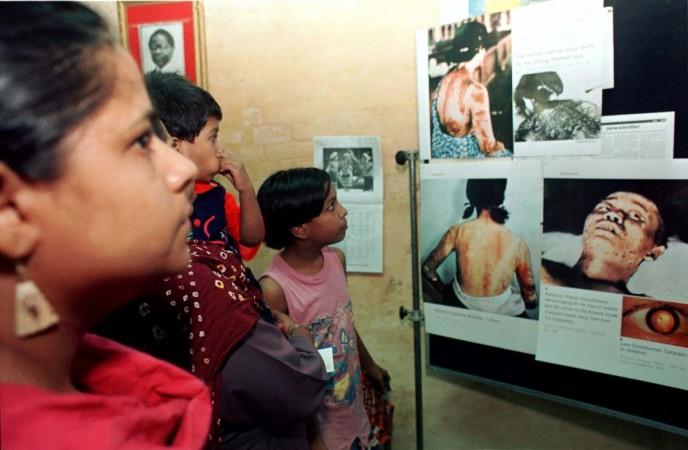 A group of Indians look at pictures showing victims of the Hiroshima bombing at a nuclear awareness exhibition in New Delhi June 16. Nuclear bomb Hiroshima