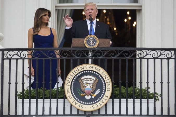 U.S. President Donald Trump delivers remarks as first lady Melania Trump looks on from the Truman Balcony on July 4, 2017, in Washington, DC. The president was hosting a picnic for military families for the July 4 holiday. Melania Trump