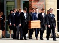 The casket of Otto Warmbier is carried to the hearse followed by his family and friends after a funeral service