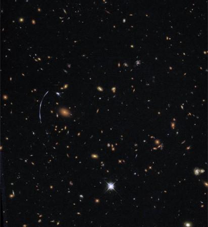 The galaxy cluster SDSS J1110 6459 is located about 6 billion light-years from Earth and contains hundreds of galaxies. NASA stars