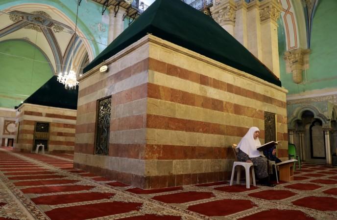 In picture: A Palestinian woman reads the Koran inside Ibrahimi Mosque, which Jews call the Jewish Tomb of the Patriarchs, in the West Bank city of Hebron on July 7, 2017. Hebron