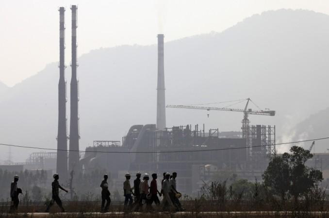 Workers walk in front of the Vedanta factory Vedanta Orissa