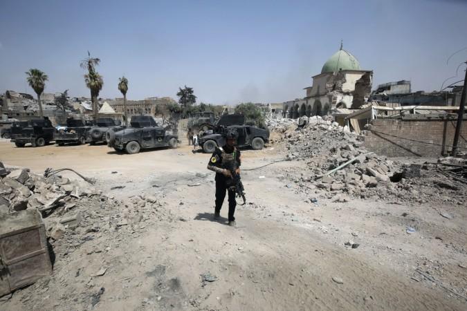 A member Iraqi Counter-Terrorism Service (CTS) walks down a street in front of Al-Nuri Mosque in Mosul's Old City on July 4, 2017, during the ongoing offensive to retake the city from Islamic State (IS) group fighters. Al-Nuri Mosque