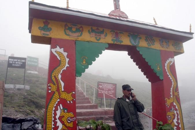 An Indian soldier stands under the gate to a war memorial near the India-China trade route at Nathu-La. Nathu La