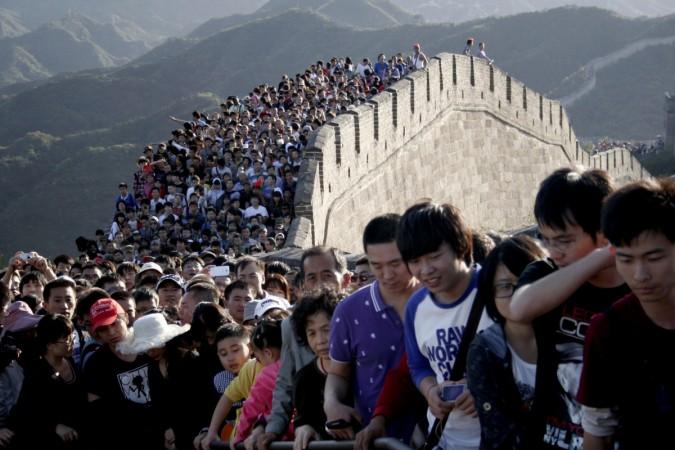 Tourists gather on the Great Wall outside Beijing, October 3, 2012. The world's population will reach 11.2 billion in 2100, according to projections by the United Nations. World Population Day