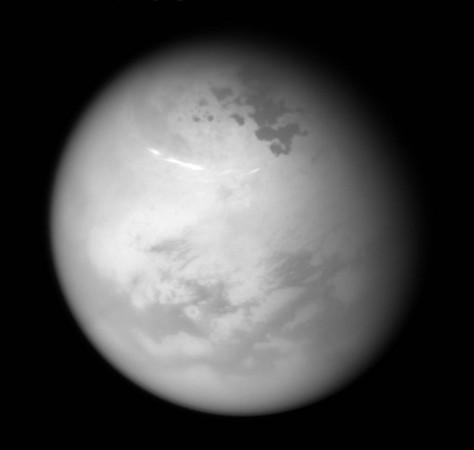 ASA's Cassini spacecraft sees bright methane clouds drifting in the summer skies of Saturn's moon Titan, along with dark hydrocarbon lakes and seas clustered around the north pole. nasa, Cassini, Saturn, Titan, moon, lake, sea,