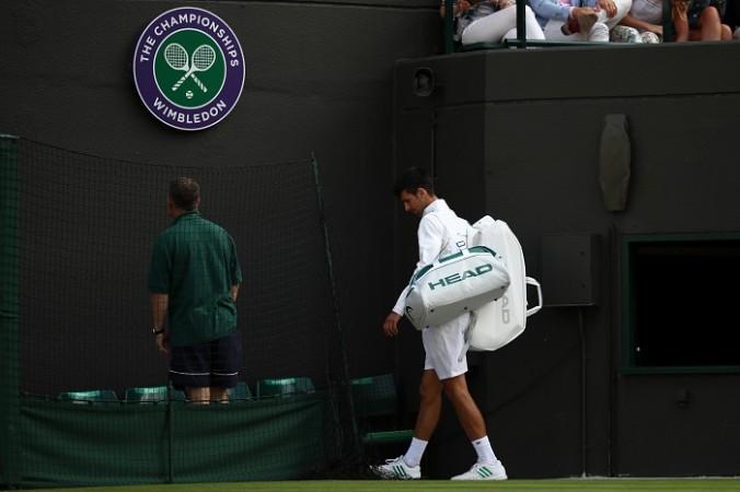 Novak Djokovic walks out of the court in disappointment after retiring hurt, July 12, 2017 Novak Djokovic, Wimbledon 2017, men's singles, quarterfinals, Tomas Berdych