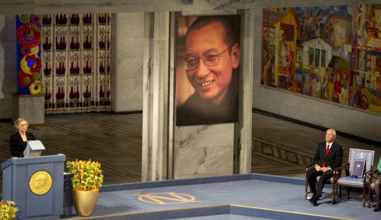 Norwegian actress Liv Ullmann (L) reads Liu Xiaobo's text 'I have no enemies' next to the The Nobel Peace Prize committee Chairman Thorbjoern Jagland (R) sitting next to an empty chair at the ceremony for the Nobel Laureate and dissident Liu Xiaobo at the city hall in Oslo, on December 10, 2010. Liu Xiaobo