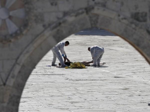 In picture: The bodies of one of those killed in the Jerusalem terror attack on Friday, July 14, 2017, is being removed. Jerusalem terror attack
