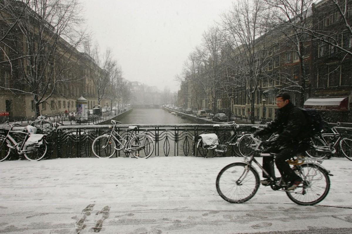 A cyclist braves the snow on February 8, 2007, in Amsterdam, Netherlands. Amsterdam