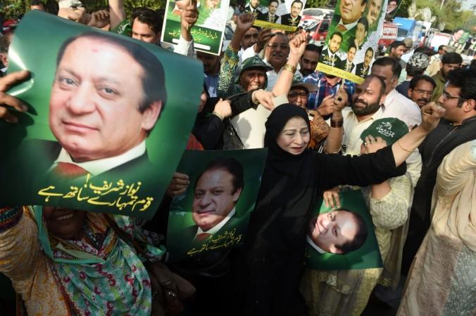 Supporters of the ruling party Pakistan Muslim League-Nawaz (PML-N) carry posters of Prime Minister Nawaz Sharif as they hold a rally after a Supreme Court verdict on the Panama Papers in Lahore on April 20, 2017. Panama Papers