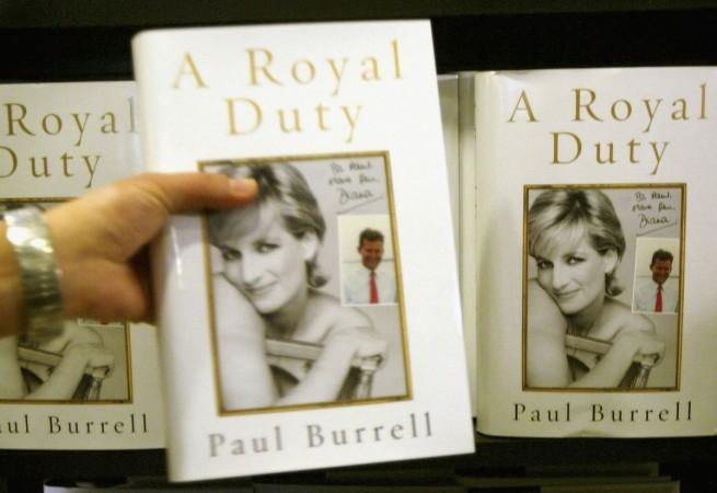 A <span>Waterstones</span> Piccadilly Circus employee stacks shelves with copies of Paul Burell's new book 'A Royal Duty' October 27, 2003 in London. Paul Burell's Book