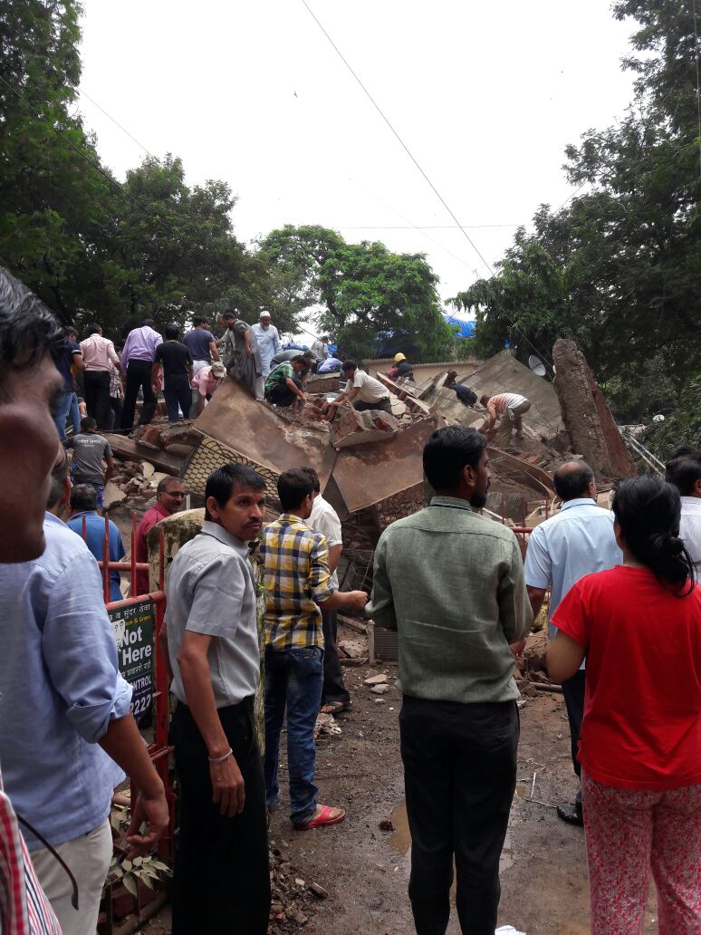 Locals gather round the rubble of the collapsed building. Ghatkopar building collapse