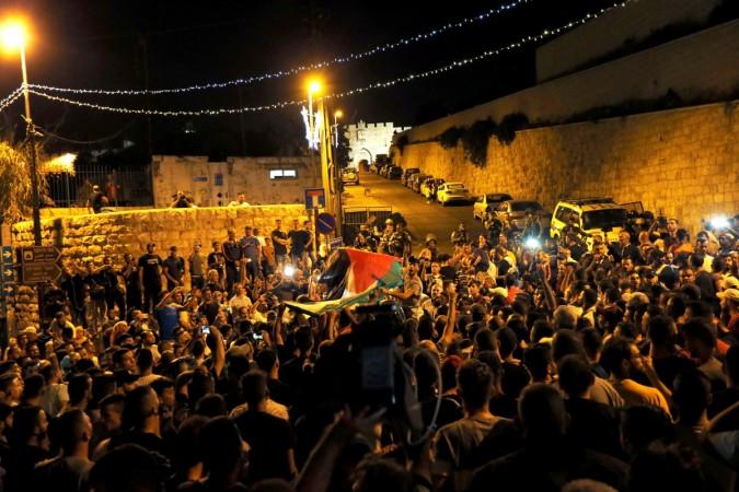 Palestinians celebrate outside Lion's gate at the entrance to Jerusalem's Old City following Israel's removal of security measures July 27, 2017. Israel