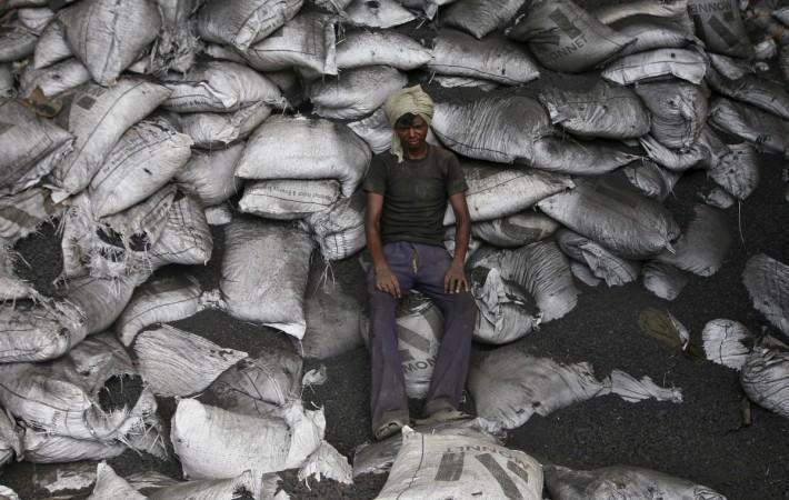 ALL SACKED UP: A worker rests on sacks filled with sponge iron at a steel factory on the outskirts of Jammu on July 10, 2014. REUTERS/Mukesh Gupta Iron ore