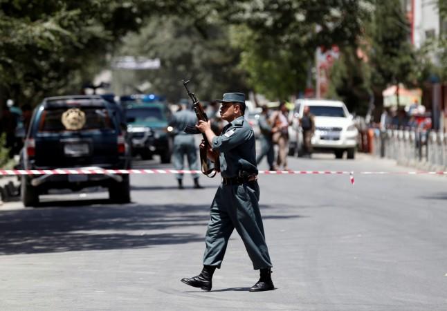 An Afghan police man stands guard at the site of attack in Kabul, Afghanistan . Kabul Blast