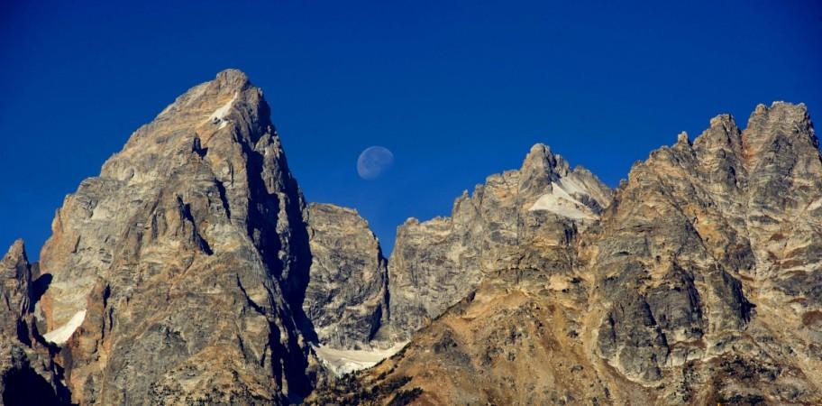 The Moon sets next to the Grand Teton (L) October 4, 2012 in the Grand Teton National Park in Wyoming. Grand Tetons National Park