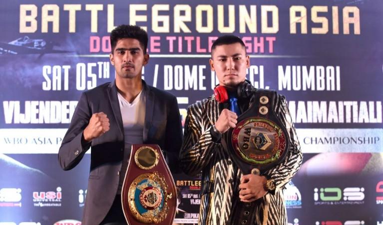 WBO Asia-Pacific Super Middleweight champion Vijender Singh (L) and his competitor WBO Oriental Super Middleweight champion China's Zulpikar Maimaitiali Vijender Singh