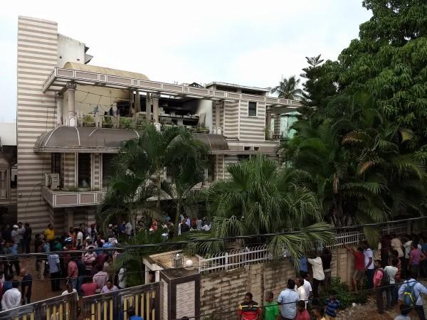 People gather after the fire is doused in Satpal Singh's house in Bhubaneshwar on Thursday. Odisha fire