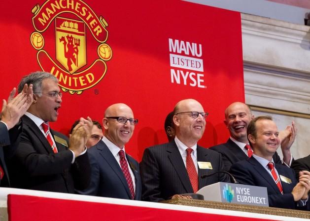 Manchester United Executives Joel Glazer (2nd L) and Avram Glazer (C) and Ed Woodward prepare to ring the Opening Bell at the New York Stock Exchange on August 10, 2012 in New York City manchester united