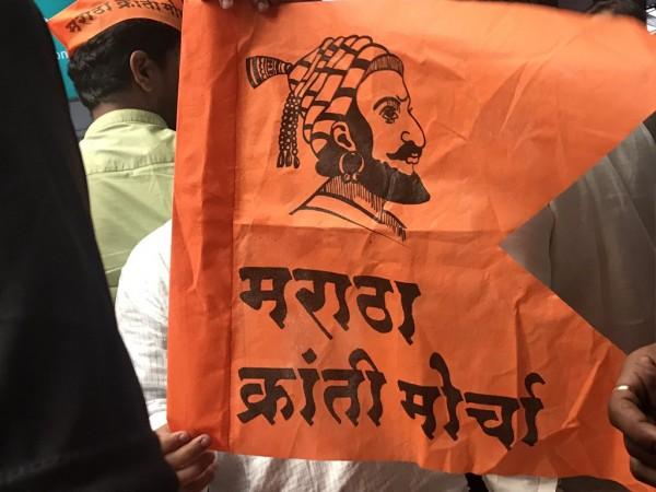 Maratha morcha flag held by a protester in Mumbai on August 9. Maratha Kranti Morcha