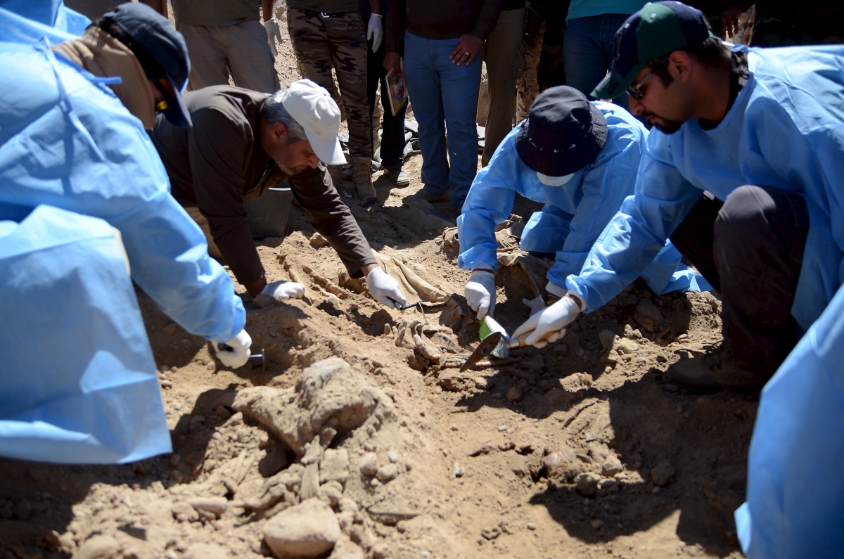 Iraqi forensic teams excavating 12 suspected mass grave sites thought to hold the corpses of as many as 1,700 soldiers massacred last summer by Islamic State militants as they swept across northern Camp Speicher massacre in 2014