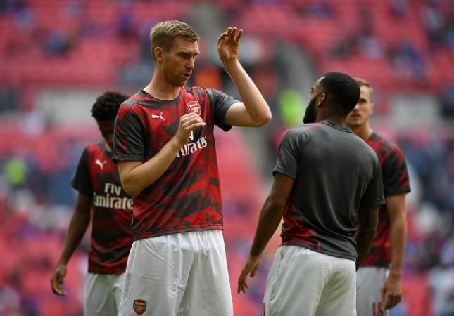 Per Mertesacker and Alexandre Lacazette, two important players either end of the pitch for Arsenal Per Mertesacker, Alexandre Lacazette, Arsenal