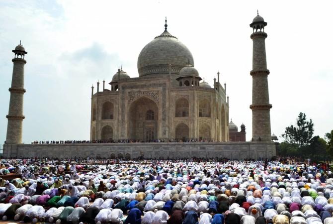 Indian Muslim devotees offer Eid prayers at the start of the Eid al-Fitr holiday which marks the end of Ramadan at the Taj Mahal in Agra on July 18, 2015. Taj Mahal