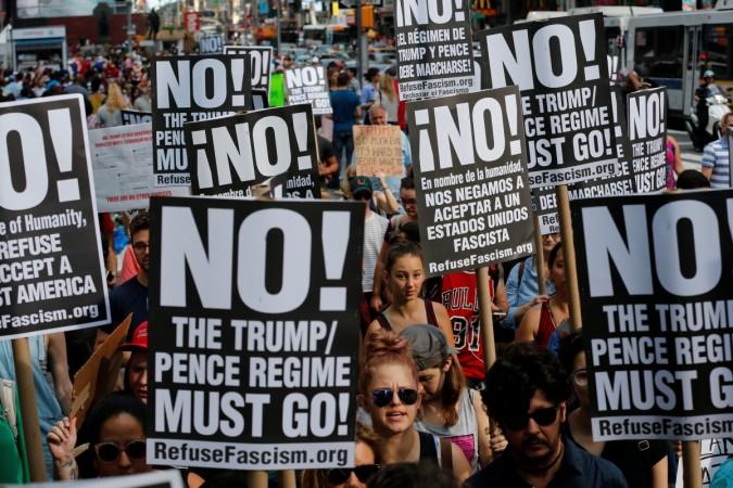 In picture: Protesters hold signs reading Charlottesville protest