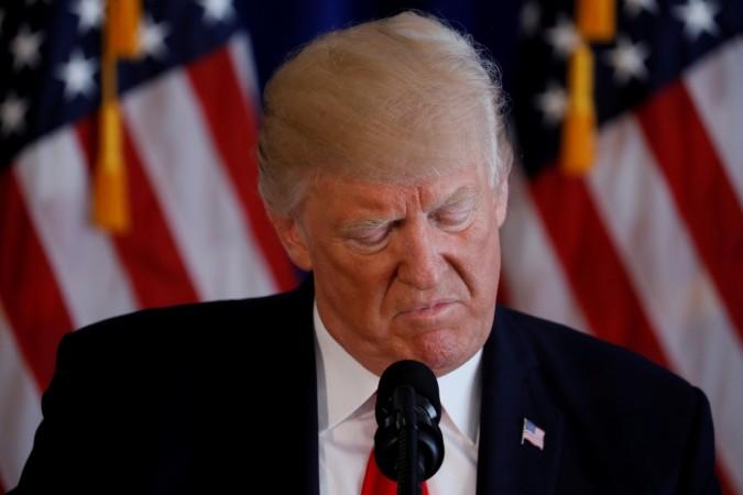 US President Donald Trump reads from a prepared statement as he delivers remarks on the protests in Charlottesville, Virginia, from his golf estate in Bedminster, New Jersey US, August 12, 2017. US President Donald Trump