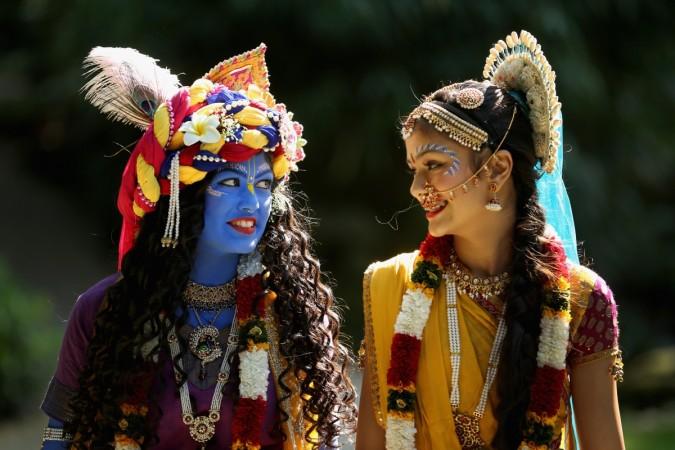 Laxmipriya Patel (L), aged 20, dressed as the Hindu god Lord Krishna, and her sister Mohini Patel, aged 13, dressed as Lord Krishna's devotee Radharani, walk through the George Harrison Memorial Garden during the Janmashtami Hindu Festival at Bhaktivedanta Manor in Watford, England. Krishna Janmashtami