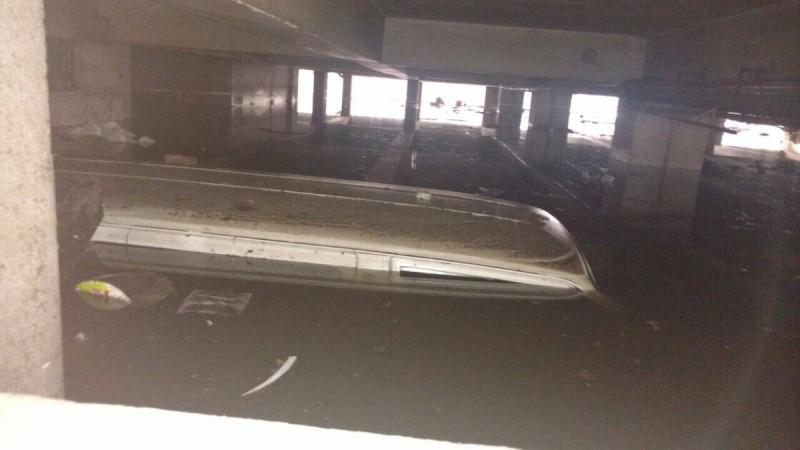 In picture: A submerged vehicle in a basement in the JC Road area of Bengaluru after rain on Tuesday, August 15, 2015. JC Road