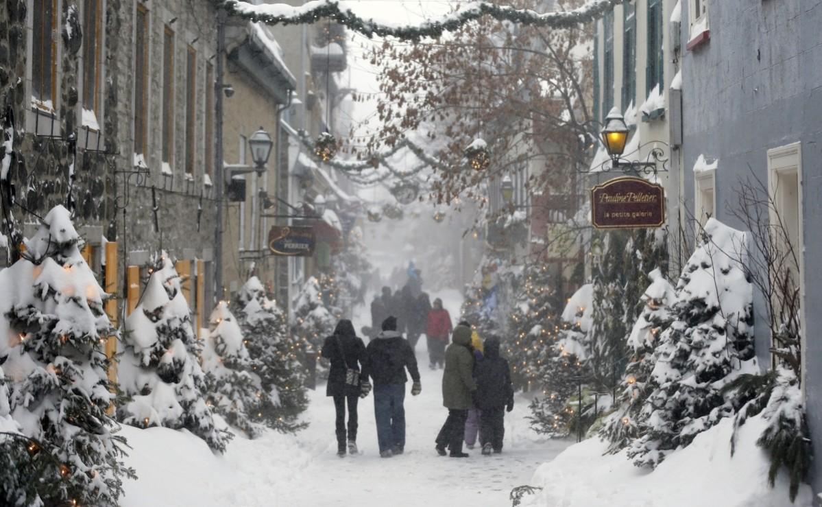 People walk in the old town during a snowstorm in Quebec City, Canada Quebec City, Canada