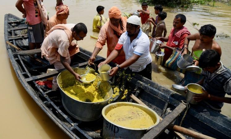 India Hindu monks from the 'Bharat Sevashram Sangha' socio-religious organisation use a boat to bring food donations to villagers affected by flooding in areas around Udaynarayanpur, some 83kms west of Kolkata, on August 1, 2017. West bengal floods