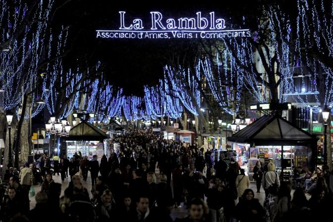 People walk the Christmas illuminations at La Rambla of Barcelona on December 2, 2011. Las Ramblas