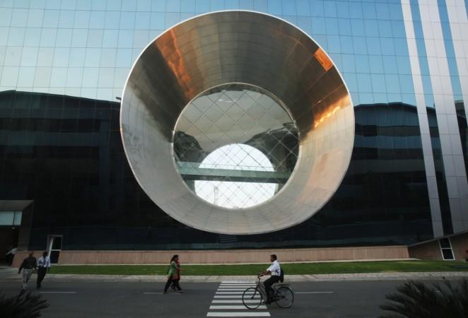 CLEAN TIDINGS: Employees walk and cycle in front of a building dubbed the Infosys