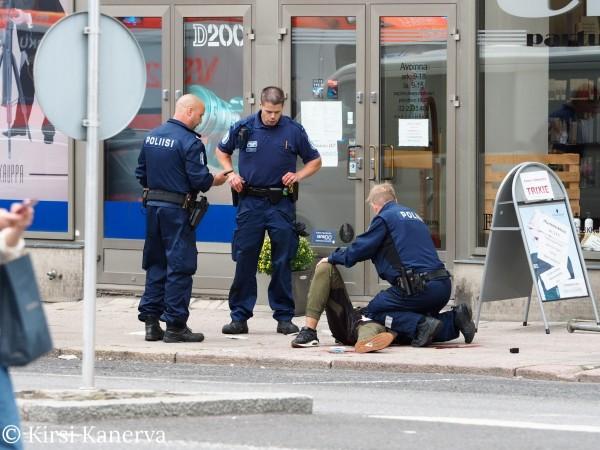The suspect lies on the ground surrounded by police officers at the Market Square where several people were stabbed, in Turku, Finland August 18, 2017. Finland Attack