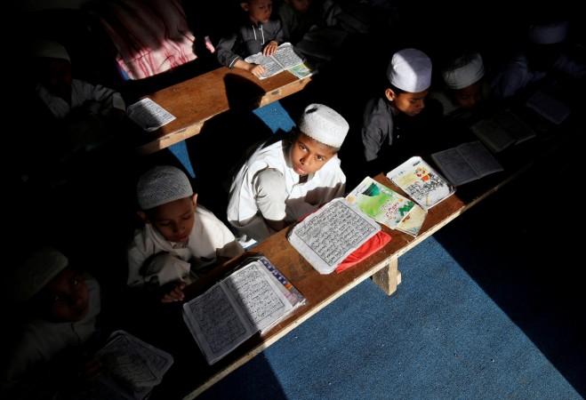 Children study at a madrasa, a religious school for Muslims. Children study at a madrasa
