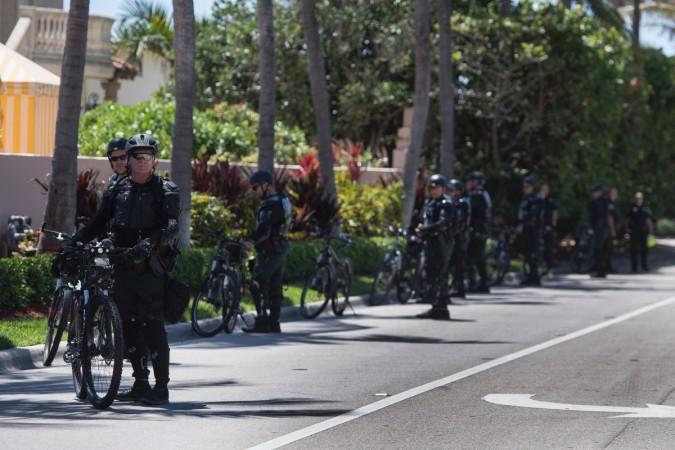 Bike policemen stand in riot gear outside the Mar-a-Lago estate in West Palm Beach, Florida, April 7, 2017, as US President Donald Trump meets with Chinese President Xi Jinping. Mar-a-Lago