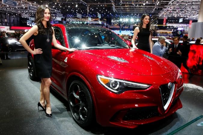 Models pose next to the new Alfa Romeo Stelvio during the 87th International Motor Show at Palexpo in Geneva, Switzerland, March 7, 2017 Alfa Romeo Stelvio